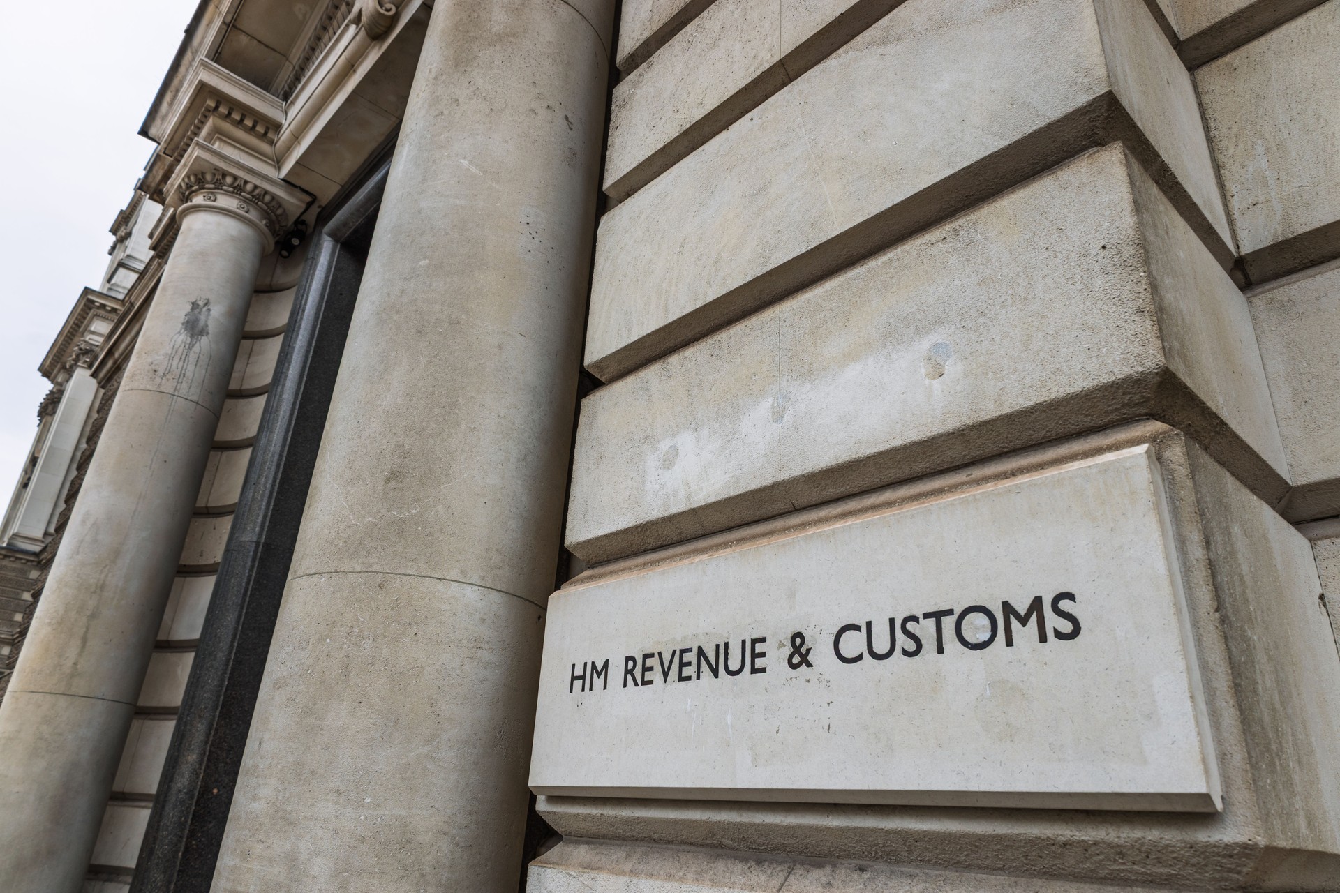 HM Revenue and Customs sign on official government building representing UK tax authority HM Revenue and Customs sign on official government building representing UK tax authority